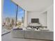Bright living room in this condo with floor to ceiling city views and modern gray sectional at 3726 Las Vegas Blvd # 1902, Las Vegas, NV 89158