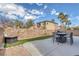 This private backyard has an outdoor dining set, patio, artificial turf, and fire pit perfect for entertaining at 3964 Irvin Ave, Las Vegas, NV 89141