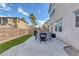 This fenced backyard has an outdoor dining set, patio, and artificial turf with privacy for outdoor relaxation at 3964 Irvin Ave, Las Vegas, NV 89141