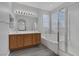 Serene bathroom showcasing a double sink vanity, a soaking tub, and a separate glass-enclosed shower, designed for relaxation at 3964 Irvin Ave, Las Vegas, NV 89141