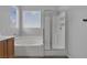 Bright bathroom with a soaking tub and glass-enclosed shower, designed for a relaxing and spa-like experience at 3964 Irvin Ave, Las Vegas, NV 89141