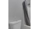 Neutral bathroom showcasing a shower with a gray shower curtain at 3964 Irvin Ave, Las Vegas, NV 89141