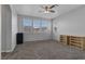 Spacious bedroom filled with natural light, featuring plush carpeting and a modern ceiling fan at 3964 Irvin Ave, Las Vegas, NV 89141