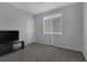 Cozy bedroom with plush carpeting, a large window for natural light, and ample space for relaxation at 3964 Irvin Ave, Las Vegas, NV 89141
