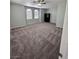 A large bedroom featuring neutral walls, carpet flooring, two arched windows, and a ceiling fan with lighting at 3964 Irvin Ave, Las Vegas, NV 89141