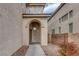 Arched entryway featuring stone accents, a modern front door, and desert landscaping at 3964 Irvin Ave, Las Vegas, NV 89141