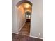 Charming arched entryway with wood-look floors leading to a well-lit bathroom at 3964 Irvin Ave, Las Vegas, NV 89141