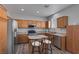 Well-lit kitchen features stainless steel appliances, light wood cabinetry, and a center island with barstool seating at 3964 Irvin Ave, Las Vegas, NV 89141