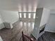 View from the top of the stairs to the living room with fireplace and hardwood floors at 3964 Irvin Ave, Las Vegas, NV 89141