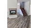 Living room with fireplace, wood floors and staircase with carpet runner at 3964 Irvin Ave, Las Vegas, NV 89141
