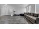 Open living space with a large couch, a treadmill, wood-look floors, and natural lighting at 3964 Irvin Ave, Las Vegas, NV 89141