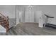 Spacious living area with wood-look floors, a staircase, and multiple entryways at 3964 Irvin Ave, Las Vegas, NV 89141