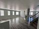 Open-concept living room with wood-look flooring, fireplace and an abundance of windows at 3964 Irvin Ave, Las Vegas, NV 89141