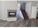 Living room with fireplace, wood floors and staircase with carpet runner at 3964 Irvin Ave, Las Vegas, NV 89141