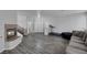 Spacious living room featuring wood-look floors, a fireplace, and staircase at 3964 Irvin Ave, Las Vegas, NV 89141