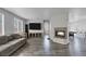 Bright living room with wood-look floors, a fireplace, and a view into the dining area at 3964 Irvin Ave, Las Vegas, NV 89141