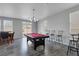 Open living space with pool table features natural light and leads to an outdoor area at 3964 Irvin Ave, Las Vegas, NV 89141