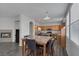 View of open floor plan shows fireplace, kitchen, and adjacent dining table with seating for six at 3964 Irvin Ave, Las Vegas, NV 89141