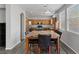 Open floor plan features kitchen with stainless appliances and adjacent dining table with seating for six at 3964 Irvin Ave, Las Vegas, NV 89141