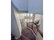 View down the carpeted stairs to the living room with fireplace at 3964 Irvin Ave, Las Vegas, NV 89141
