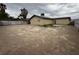 Large backyard showcasing a blank canvas with dirt, a block wall, and potential for landscaping at 4189 Studio St, Las Vegas, NV 89115