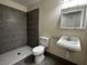 Bathroom featuring tiled walk-in shower, toilet, and sink with vanity at 4189 Studio St, Las Vegas, NV 89115