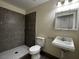 Modern bathroom featuring a walk-in shower with stylish tile, a white sink, and a mirrored medicine cabinet at 4189 Studio St, Las Vegas, NV 89115