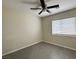 Bedroom features a ceiling fan, gray tile flooring, and a window at 4189 Studio St, Las Vegas, NV 89115