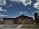 Tan single story home features a two car garage, desert landscaping, and neutral color scheme at 4189 Studio St, Las Vegas, NV 89115