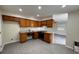 Functional kitchen with efficient layout, wooden cabinets, and updated appliances at 4189 Studio St, Las Vegas, NV 89115