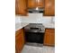 Close-up of a stainless steel oven surrounded by wood cabinetry and neutral countertop at 4189 Studio St, Las Vegas, NV 89115