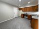 Practical kitchen featuring wood cabinetry, granite-look counters, and sleek tile flooring at 4189 Studio St, Las Vegas, NV 89115