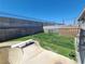 Green backyard with grass, fencing, and a diving board at 4437 Sherrill Ave, Las Vegas, NV 89110