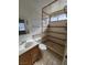 Bathroom featuring tiled walk-in shower, modern vanity, and neutral finishes at 4437 Sherrill Ave, Las Vegas, NV 89110