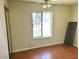 Bedroom with a window and tile flooring, illuminated by a ceiling fan with lights at 4437 Sherrill Ave, Las Vegas, NV 89110