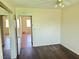 Bedroom with wood flooring and entry to a view of another room at 4437 Sherrill Ave, Las Vegas, NV 89110