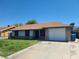 Charming single-story home with a well-maintained lawn and a spacious driveway leading to an attached garage at 4437 Sherrill Ave, Las Vegas, NV 89110
