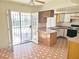 Open kitchen area with tile flooring and a sliding glass door providing natural light at 4437 Sherrill Ave, Las Vegas, NV 89110