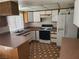 Functional kitchen featuring white cabinets, standard appliances, and durable countertops at 4437 Sherrill Ave, Las Vegas, NV 89110
