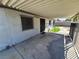 A covered patio area with a concrete surface, metal railing, and access to the backyard at 4437 Sherrill Ave, Las Vegas, NV 89110