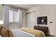 Comfortable bedroom features large window, sleek closet, and mounted television with decor at 4653 Califa Dr, Las Vegas, NV 89122