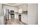 Updated kitchen showcasing stainless steel appliances, white cabinetry, and modern backsplash at 4653 Califa Dr, Las Vegas, NV 89122