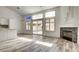 Bright living room featuring wood floors, fireplace, and sliding glass doors leading to the backyard at 4653 Califa Dr, Las Vegas, NV 89122