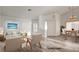 Open-concept living room with hardwood floors, a bright sofa, and formal dining area at 4653 Califa Dr, Las Vegas, NV 89122