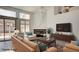 Staged living room featuring fireplace and large TV at 4653 Califa Dr, Las Vegas, NV 89122