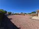 Expansive backyard featuring decorative rock and a wood fence, offering privacy and space at 4748 Terra Linda Ave, Las Vegas, NV 89120