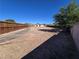 Fenced-in backyard, partially covered with gravel, shows potential for landscaping and outdoor activities at 4748 Terra Linda Ave, Las Vegas, NV 89120