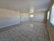 Large living room with tile flooring, bright windows, and a neutral color palette for personalized decor at 4748 Terra Linda Ave, Las Vegas, NV 89120