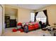 Bedroom features a drum set, closet, and a small window at 4835 Willow Glen Dr, Las Vegas, NV 89147