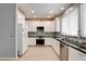 Well-lit kitchen with stainless steel appliances, white cabinets, and stylish backsplash at 4835 Willow Glen Dr, Las Vegas, NV 89147